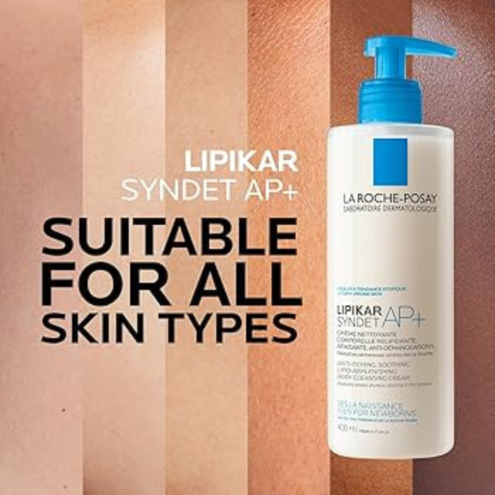 A bottle of La Roche-Posay Lipikar Syndet AP+ liquid cleanser with a blue pump, shown next to text that reads 'LIPIKAR SYNDET AP+ SUITABLE FOR ALL SKIN TYPES' against a background of vertical skin tone swatches.