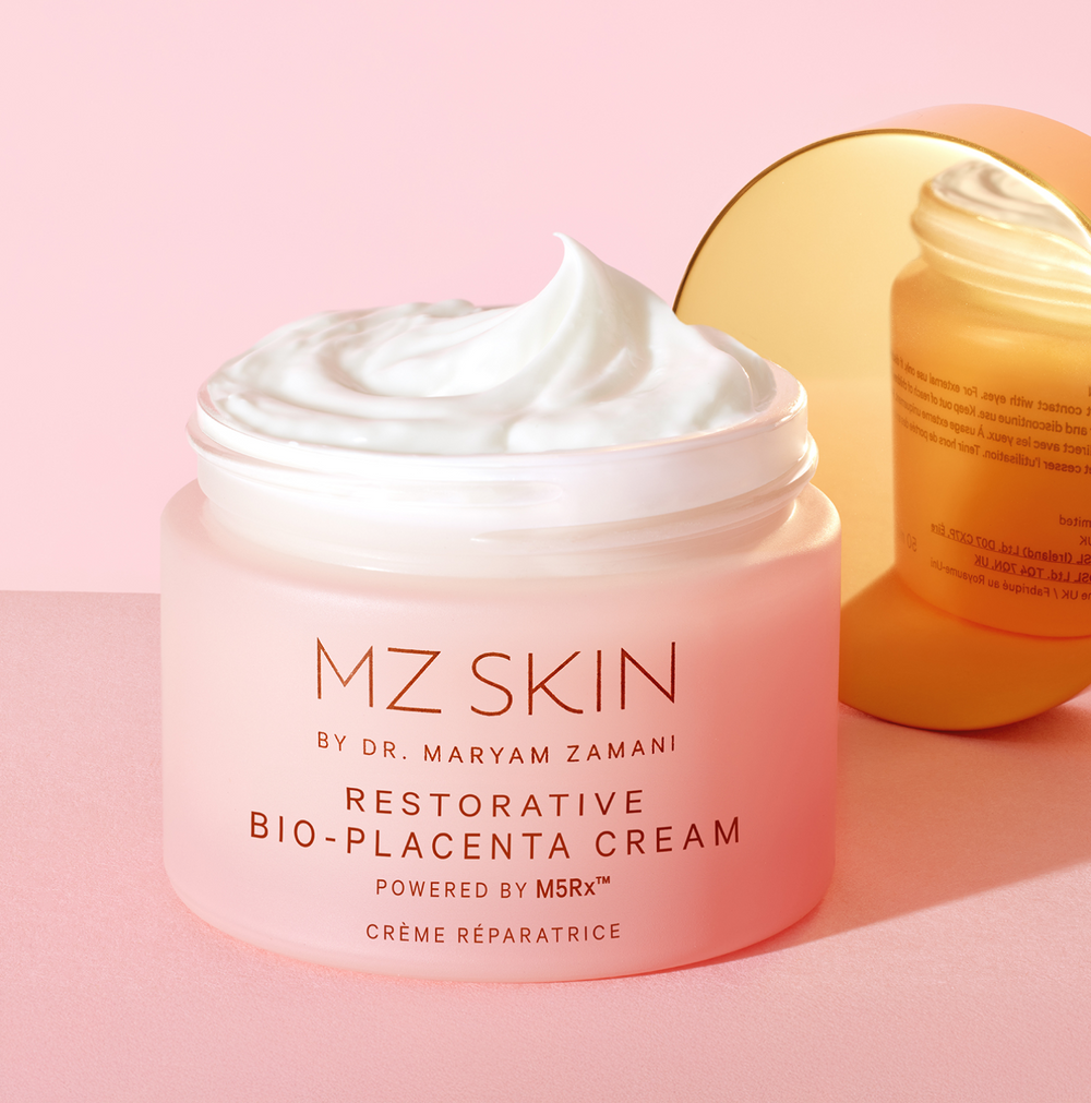 Pink jar of MZ Skin cream with a white lid on a pink background