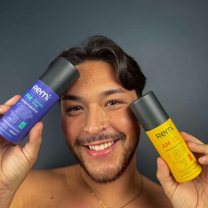 Man holding two bottles of Remi skincare products against a dark background