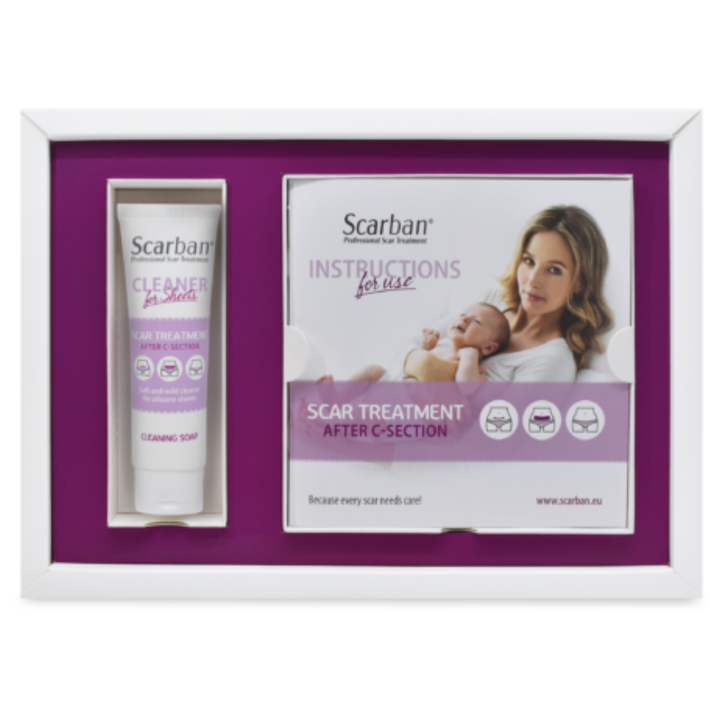 Scarban scar treatment gift set in a white box with a purple insert, containing a tube of cleaning soap and an instructions booklet.