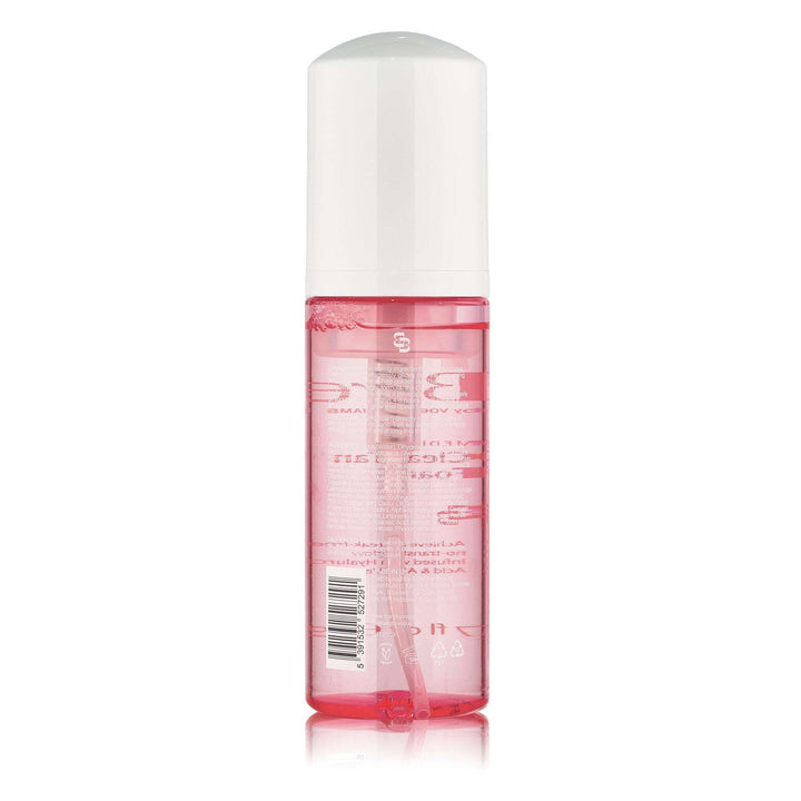 Bare by Vogue clear tanning foam in a transparent pink bottle with a white pump cap