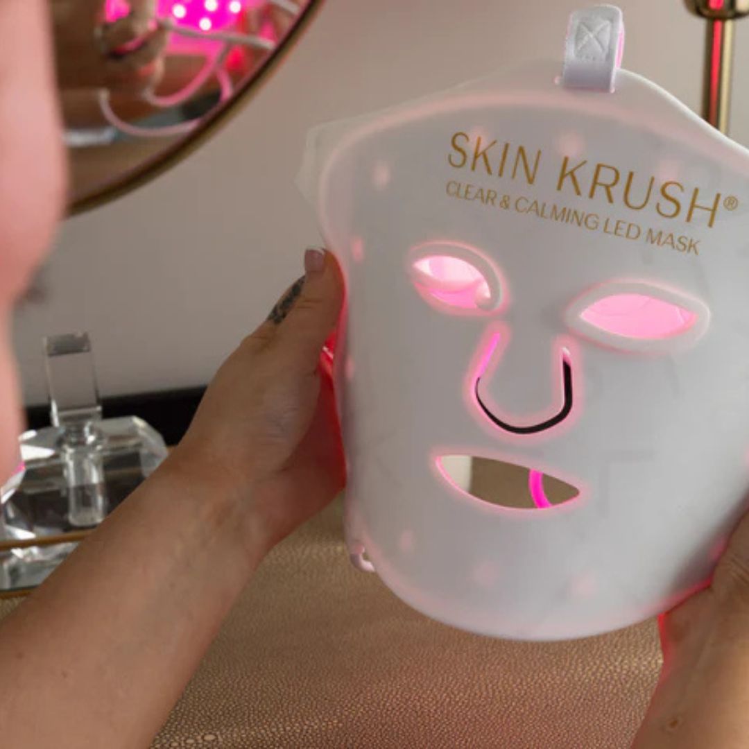 Clear and Calming LED Mask, white flexible facial mask with pink LED lights, eye openings and overhead strap