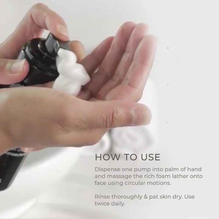 Gentle Foaming Cleanser dispensed as rich white foam from a black pump bottle into an open palm