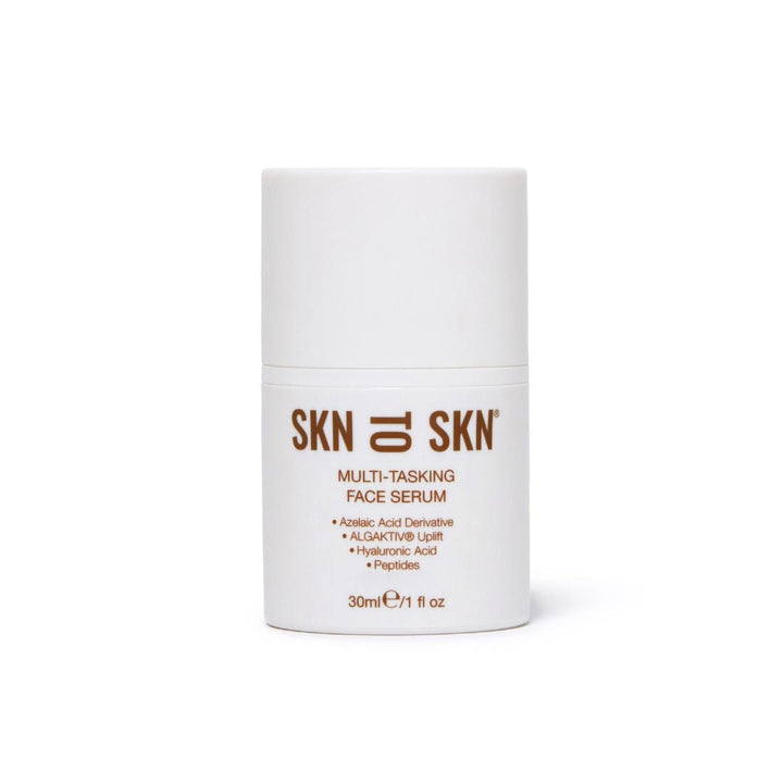 Multi-Tasking Face Serum in a white cylindrical pump bottle with brown SKN to SKN branding and label