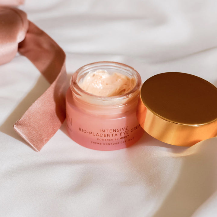 MZ Skin Intensive Bio-Placenta Eye Cream in a pink glass jar with gold lid and creamy textured formula