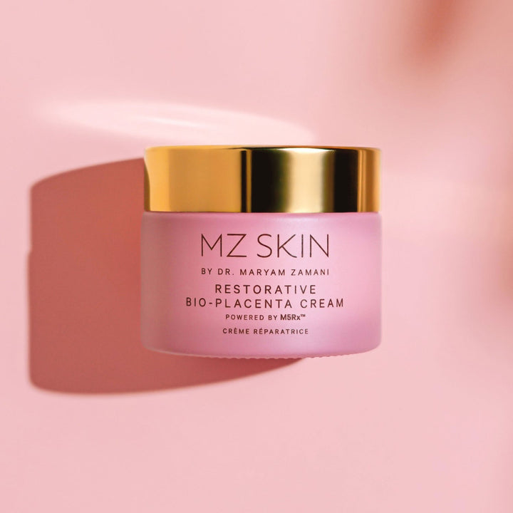 MZ Skin Restorative Bio-Placenta Cream in a pink jar with a reflective gold lid and printed front label