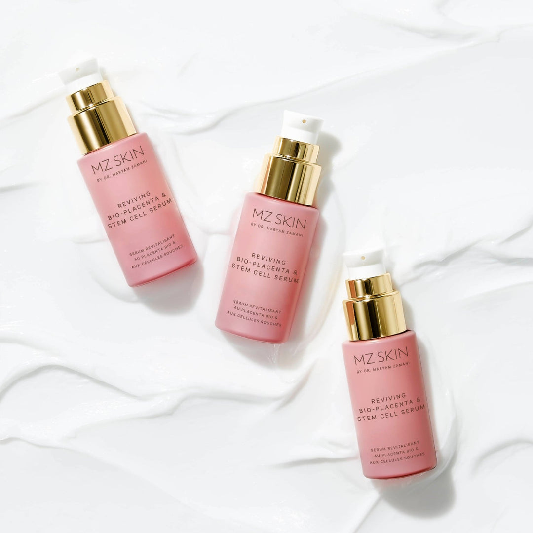 MZ Skin Reviving Bio-Placenta serum in three pink bottles with gold pump dispensers