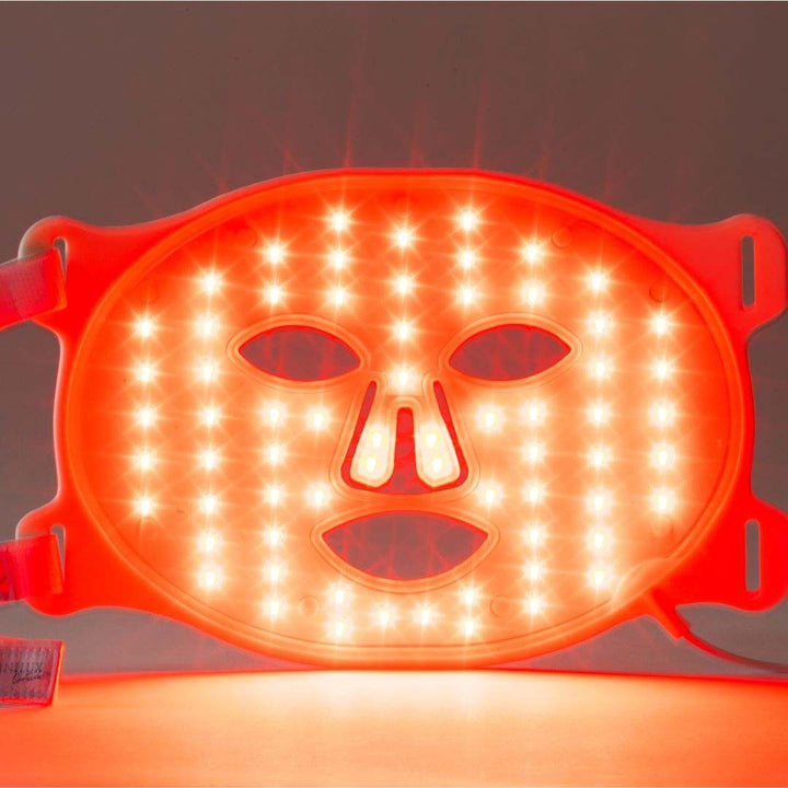 Omnilux Contour Face LED mask in flexible red silicone with illuminated LED lights and facial cutouts