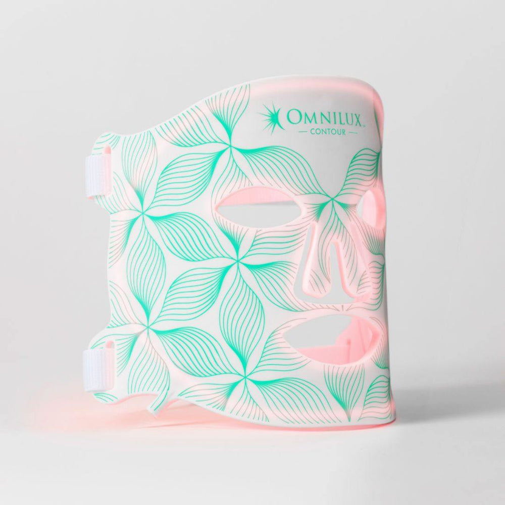 Omnilux Contour Face LED mask in white with mint and pink botanical leaf pattern and eye, nose, and mouth cutouts