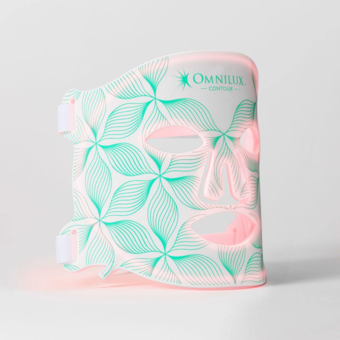 Omnilux Contour Face LED mask in white with mint and pink botanical leaf pattern and eye, nose, and mouth cutouts