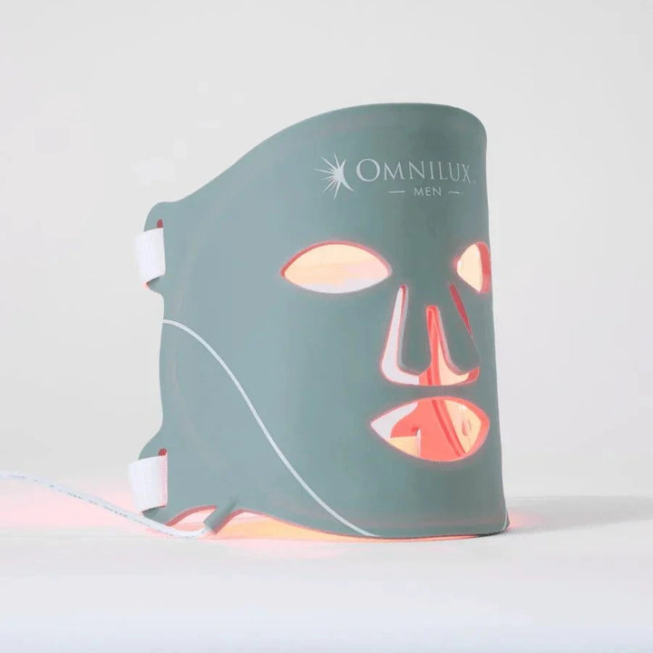 Omnilux Men LED Mask in flexible teal silicone with red LED lights, eye and mouth openings, and adjustable straps