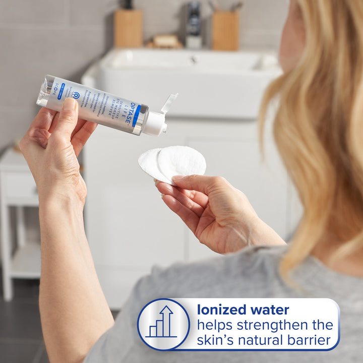 Optase Life Sensitive Eye Makeup Remover tube with white cap and cotton pad, featuring ionized water skincare claim