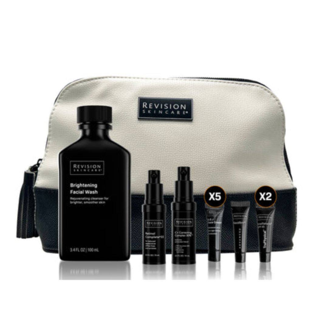 Revision Skin Radiance Kit with black skincare bottles and samples in a cream and black makeup bag