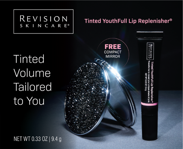 Revision Tinted Lip Replenisher black tube with pink label beside a crystal-embellished compact mirror