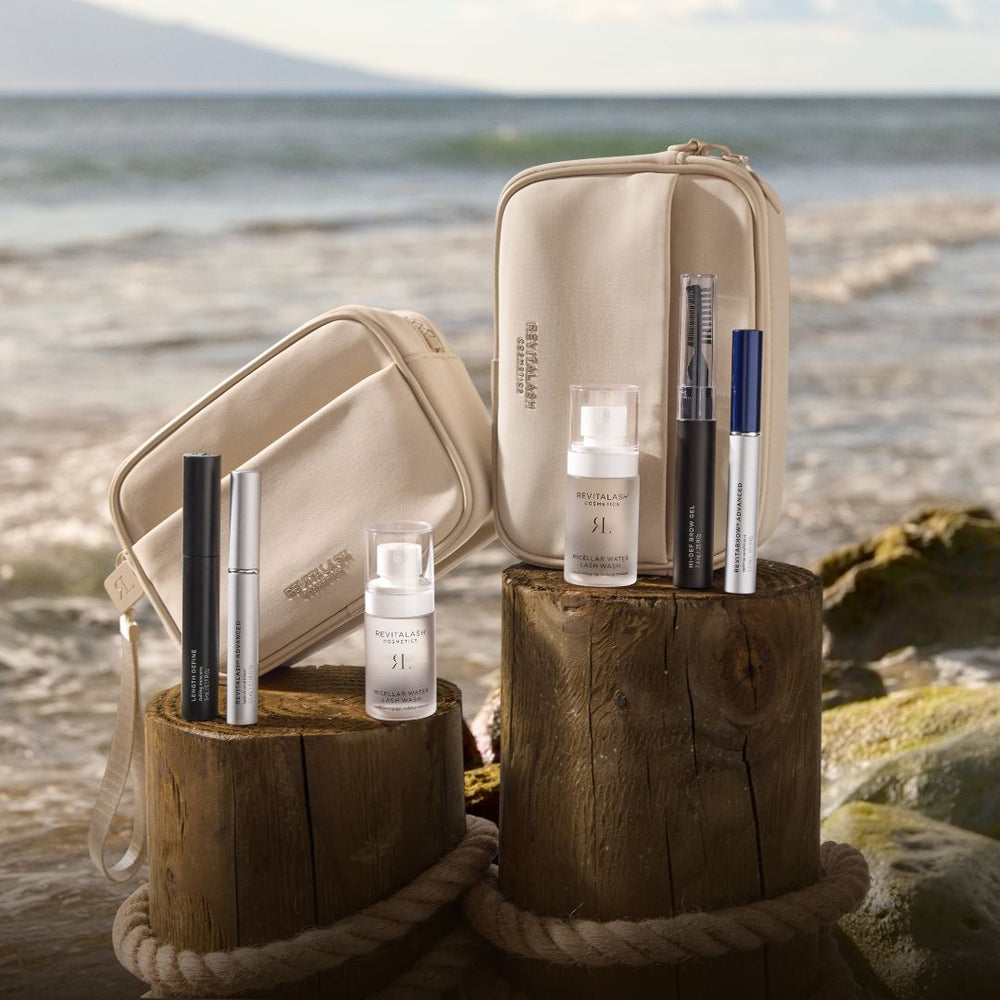 RevitaLash Strengthen & Define lash care set with black and silver tubes, clear bottles, and beige travel pouches
