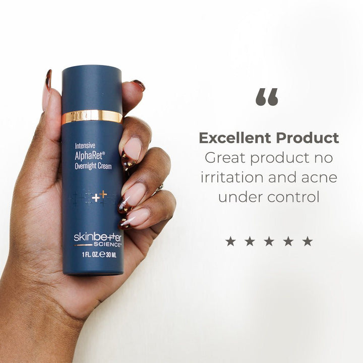 Skinbetter Science AlphaRet dark blue cylinder bottle with gold band held in hand with long brown nails, text review praising product