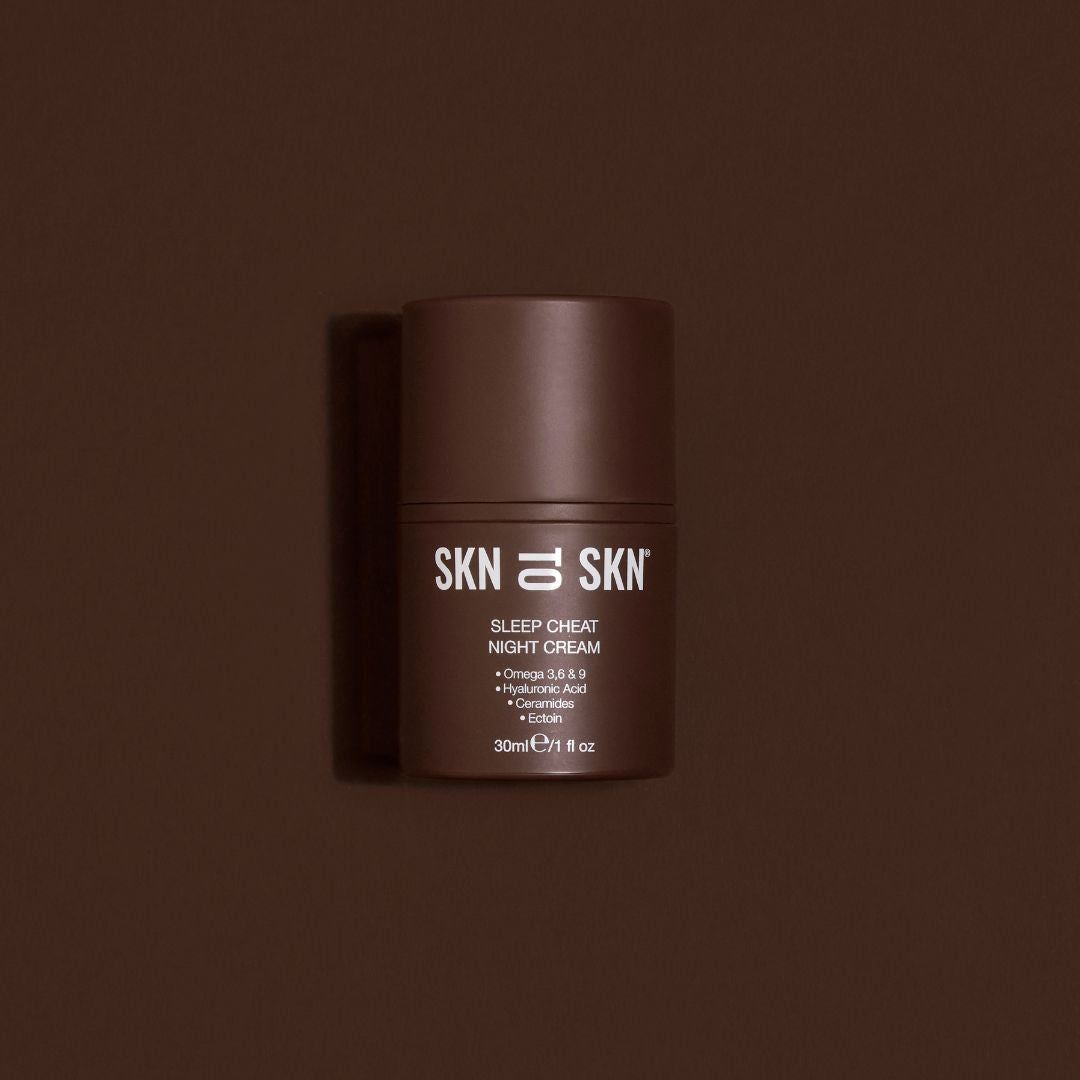 Skn to Skn Sleep Cheat Night Cream in a dark brown cylindrical jar with white label and screw-top lid