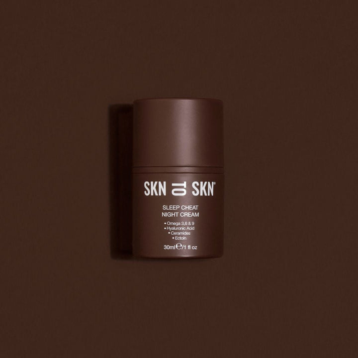 Skn to Skn Sleep Cheat Night Cream in a dark brown cylindrical jar with white label and screw-top lid
