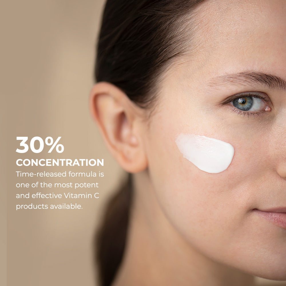 Vitamin C Lotion 30% applied on cheek of woman with fair skin showing smooth creamy white texture of lotion